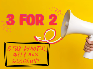 A hand holds a white megaphone with "3 FOR 2" and "STAY LONGER WITH 30% DISCOUNT" written in bold letters on a yellow background.