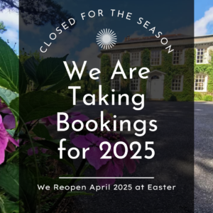 A scenic view with a building in the background and flowers in the foreground. Text reads: "Closed for the season. We are taking bookings for 2025. We reopen April 2025 at Easter.